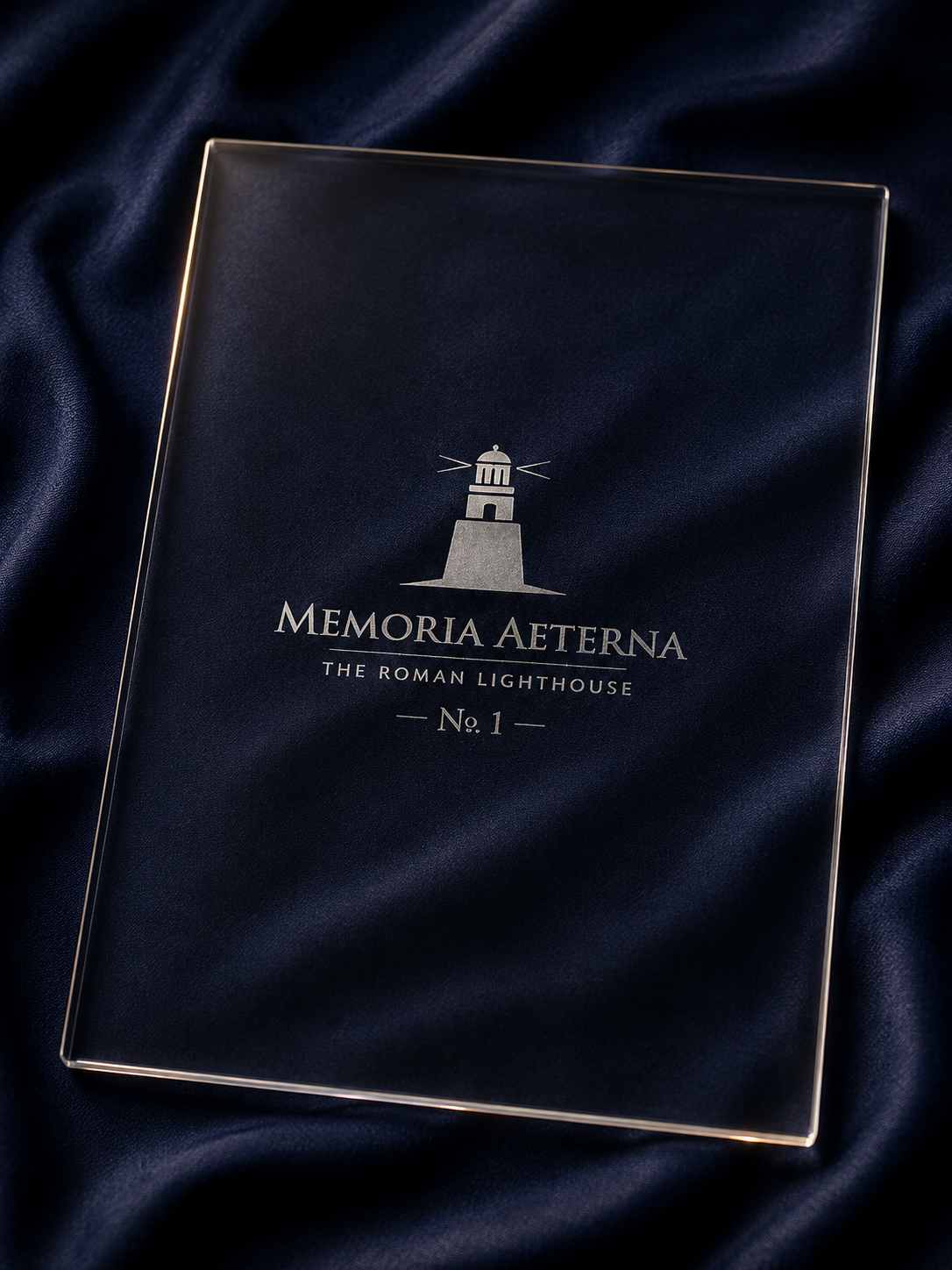 Back of the sapphire tablet with engraved lighthouse mark, on navy silk
